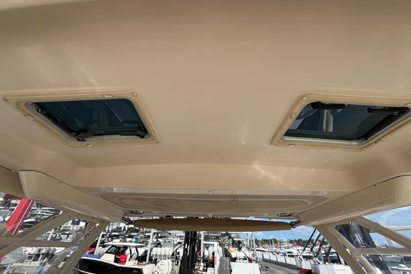 Slide: The Image of Anchor compartment of 2013 Grady-White Freedom 335 boat, featuring winch and cleats. - 85