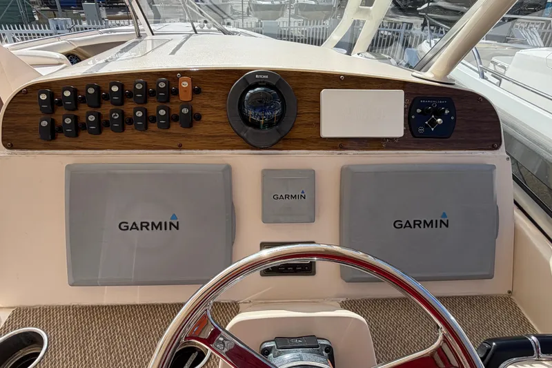 Slide: The Image of Bow of 2013 Grady-White Freedom 335 boat in a marina setting. - 89