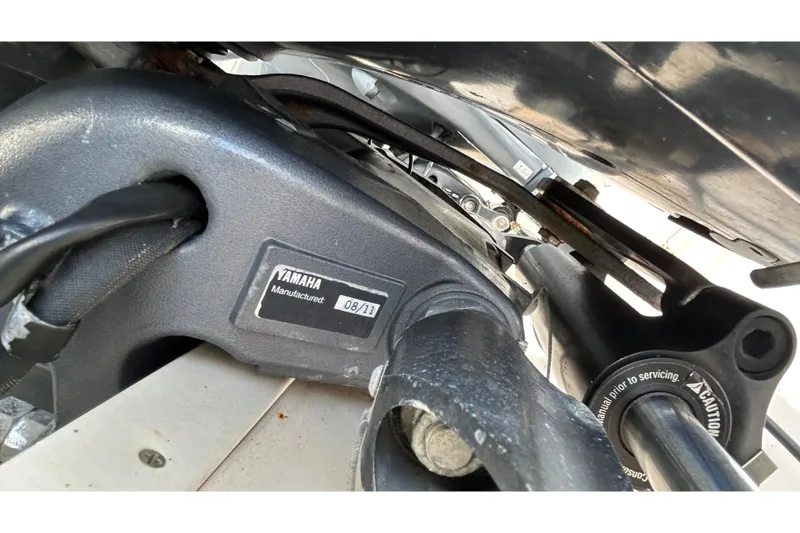 Slide: The Image of 2013 Grady-White Freedom 335 boat with cover, docked under a blue sky. - 9