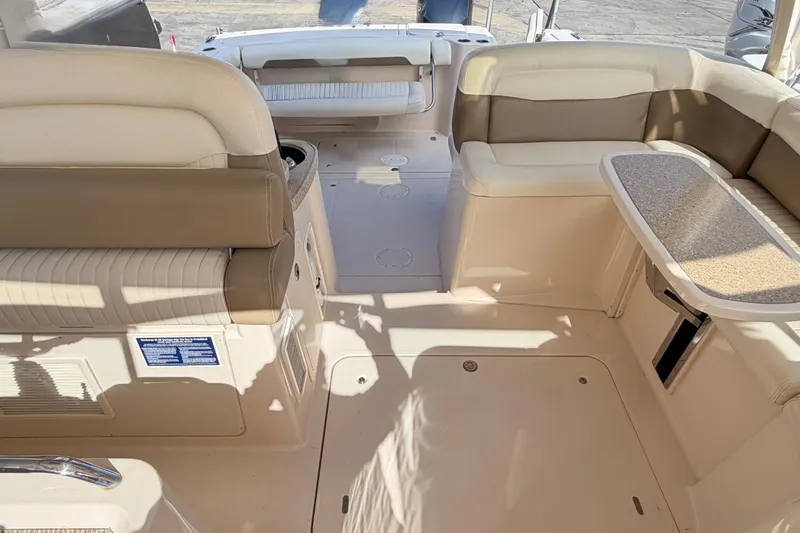 Slide: The Image of 2013 Grady-White Freedom 335 boat interior with open cockpit and seating at marina. - 90