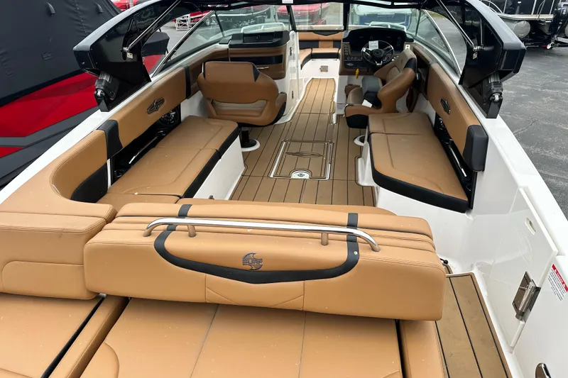 Slide: The Image of 2023 Chaparral 30 Surf boat interior with tan seating and sleek design. - 6