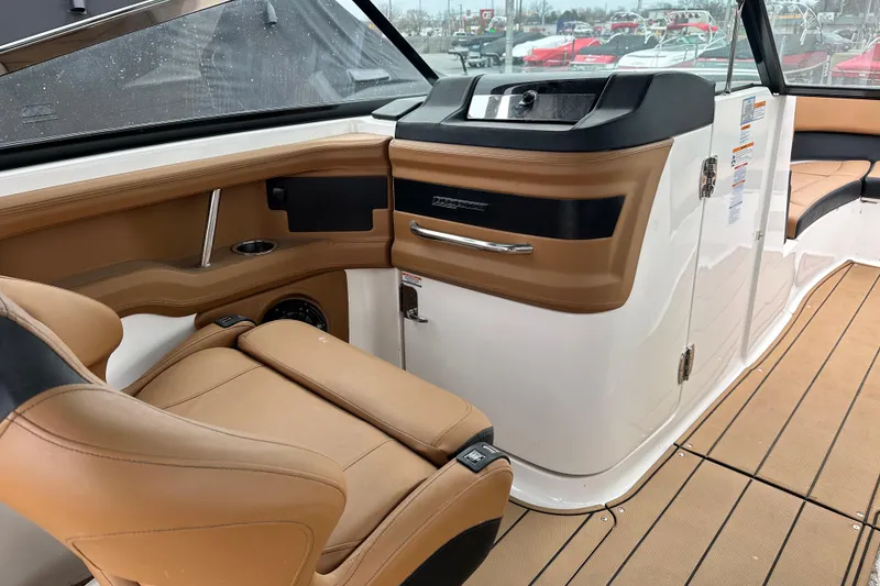 Slide: The Image of 2023 Chaparral 30 Surf boat interior with tan seating and modern dashboard. - 7