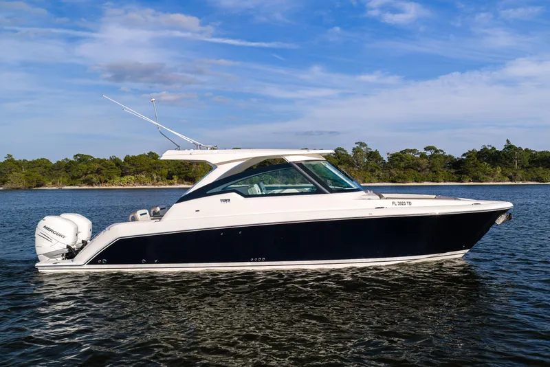 The Image of 2022 Tiara 34 LX boat on water, side view with scenic background. - 0