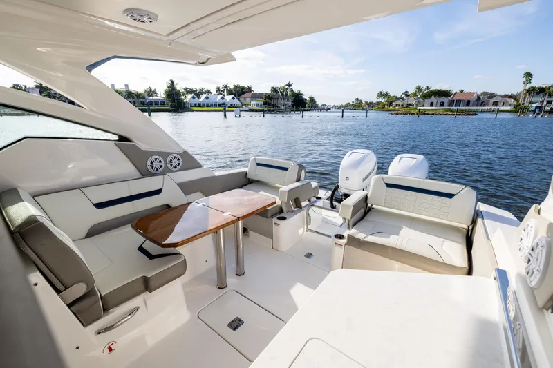 Slide: The Image of Luxurious 2022 Tiara 34 LX yacht interior with elegant seating and scenic waterfront view. - 11