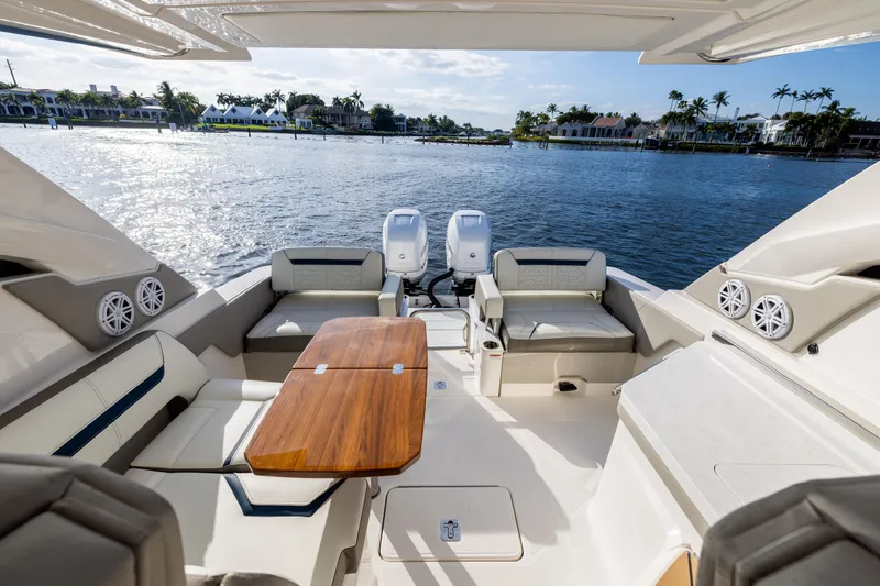 Slide: The Image of Luxurious 2022 Tiara 34 LX yacht interior with seating and table, overlooking serene waterfront. - 15