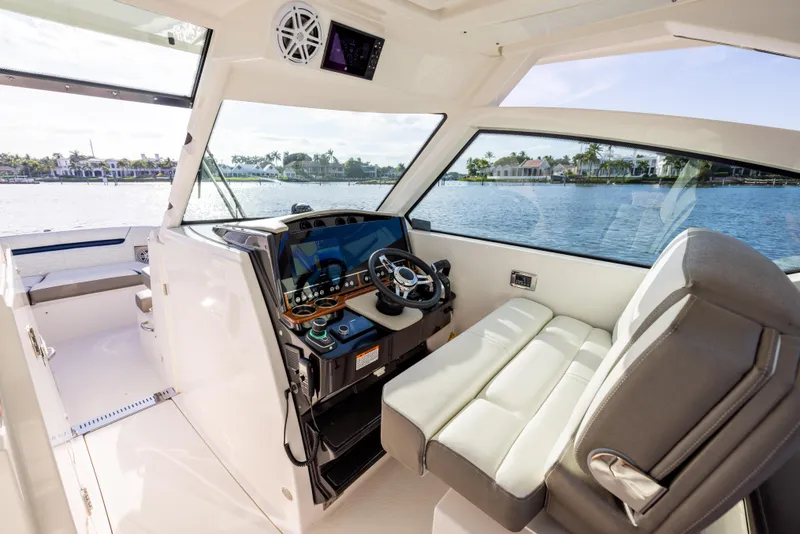 Slide: The Image of Interior view of 2022 Tiara 34 LX boat cockpit with luxurious seating and controls. - 19