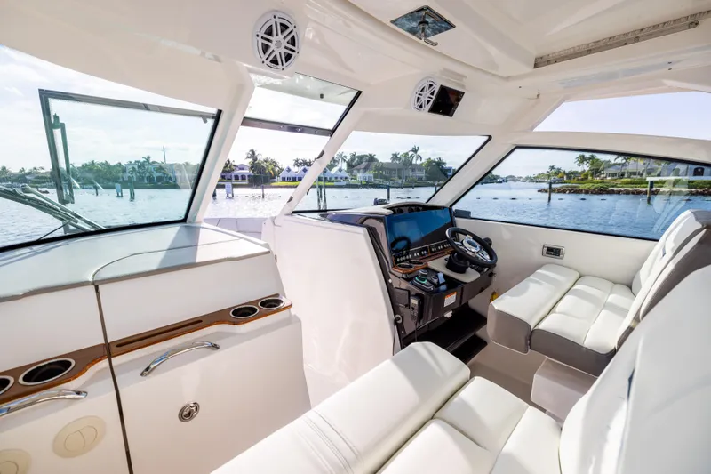 Slide: The Image of Interior of 2022 Tiara 34 LX boat with luxurious seating and modern dashboard. - 23