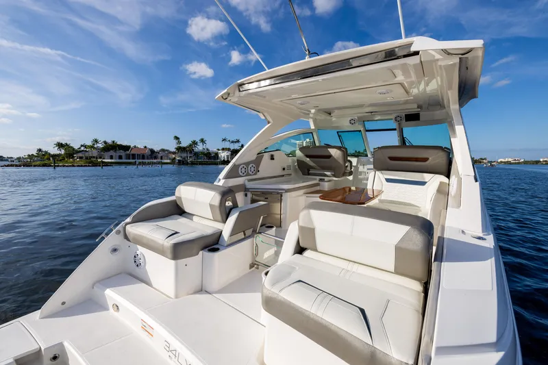 Slide: The Image of Luxurious 2022 Tiara 34 LX boat interior with plush seating on a sunny day. - 3