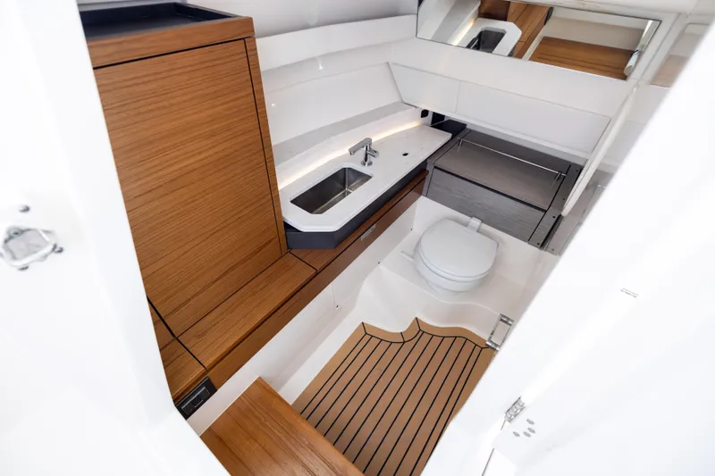 Slide: The Image of 2022 Tiara 34 LX yacht bathroom with modern wood accents and sleek fixtures. - 31