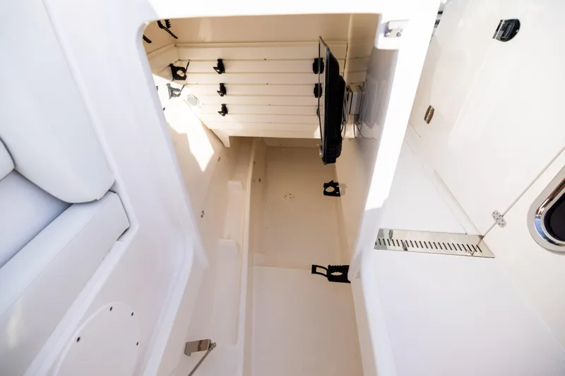 Slide: The Image of Interior storage compartment of 2022 Tiara 34 LX boat, featuring organized layout and secure fittings. - 33