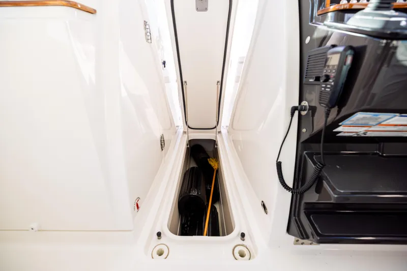 Slide: The Image of 2022 Tiara 34 LX boat storage compartment with equipment and accessories. - 34
