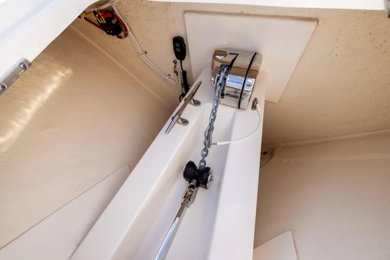 Slide: The Image of Anchor chain compartment of 2022 Tiara 34 LX boat, featuring modern equipment. - 35