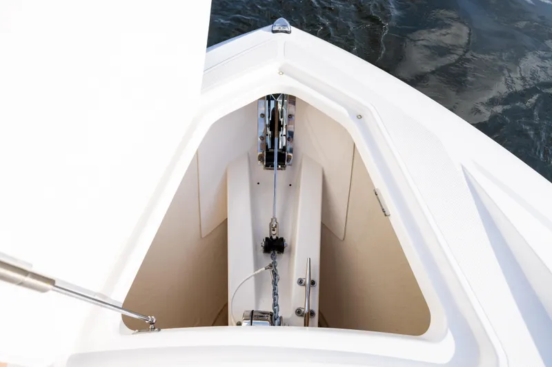 Slide: The Image of 2022 Tiara 34 LX boat anchor compartment with chain, viewed from above. - 36