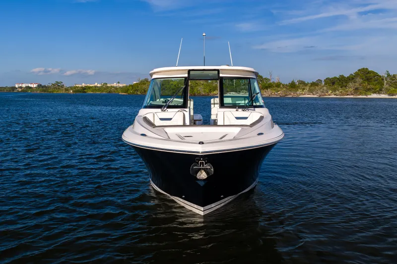 Slide: The Image of 2022 Tiara 34 LX boat on calm water with scenic background. - 44
