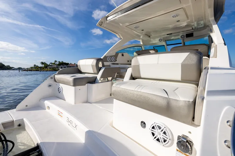 Slide: The Image of 2022 Tiara 34 LX boat interior with luxurious seating and scenic water view. - 7