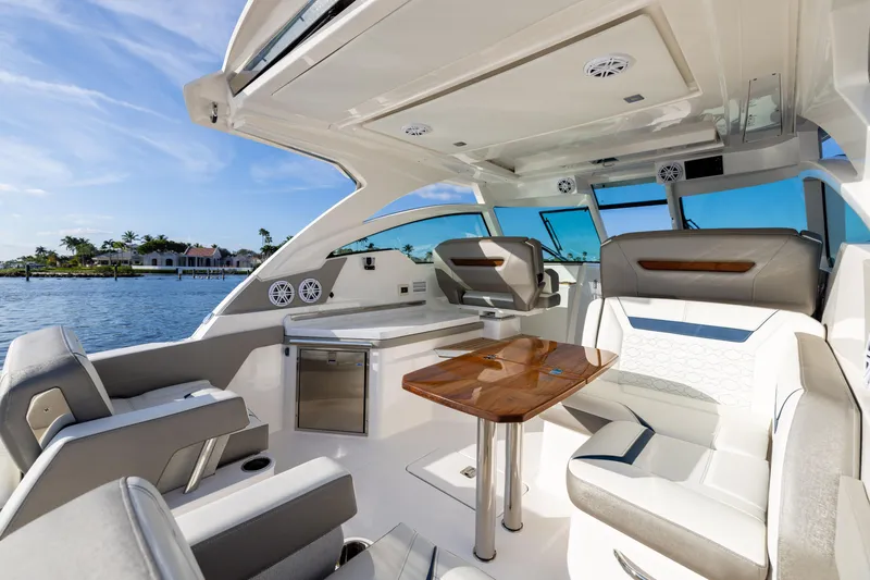 Slide: The Image of Luxurious 2022 Tiara 34 LX boat interior with elegant seating and wooden table. - 9