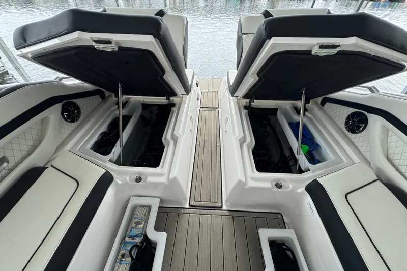 Slide: The Image of 2024 Yamaha Boats 275SD interior with open storage compartments and sleek seating design. - 14
