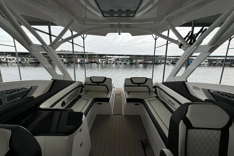 Slide: The Image of 2024 Yamaha Boats 275SD interior with luxurious seating and waterfront view. - 15