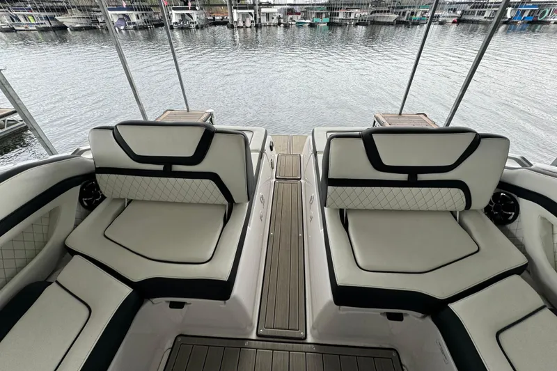 Slide: The Image of 2024 Yamaha Boats 275SD interior with luxurious seating and waterfront view. - 18