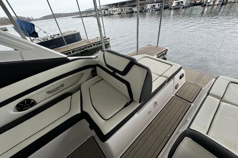 Slide: The Image of 2024 Yamaha Boats 275SD interior with luxurious seating by the water. - 8