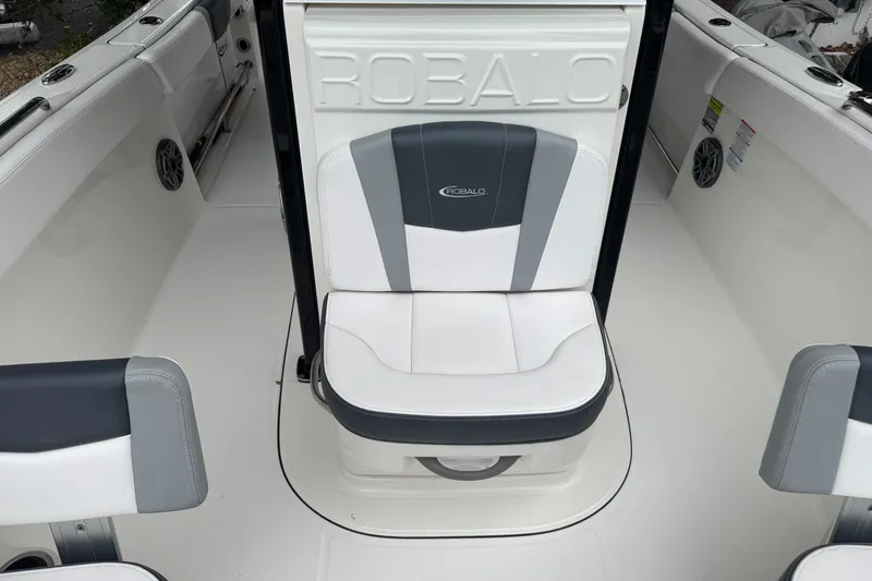 Slide: The Image of 2021 Robalo R230 Center Console boat interior with cushioned seating. - 11