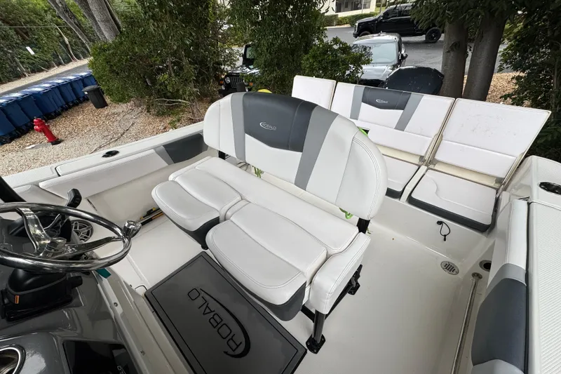 Slide: The Image of 2021 Robalo R230 Center Console boat interior with seating and steering wheel. - 16
