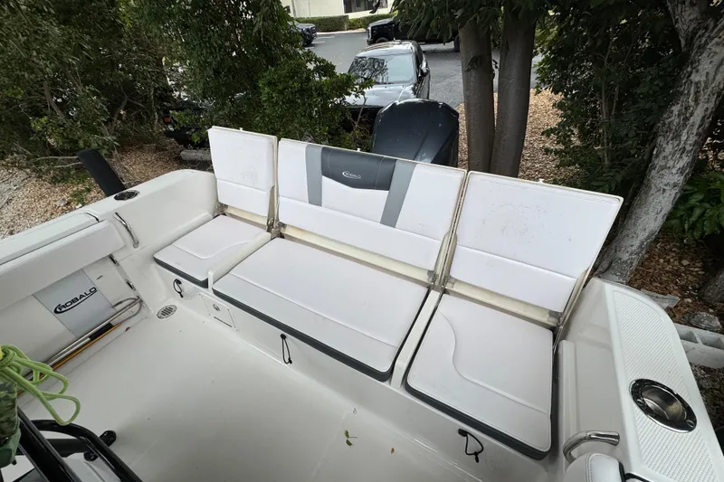 Slide: The Image of 2021 Robalo R230 Center Console boat with white seating and storage compartments. - 17