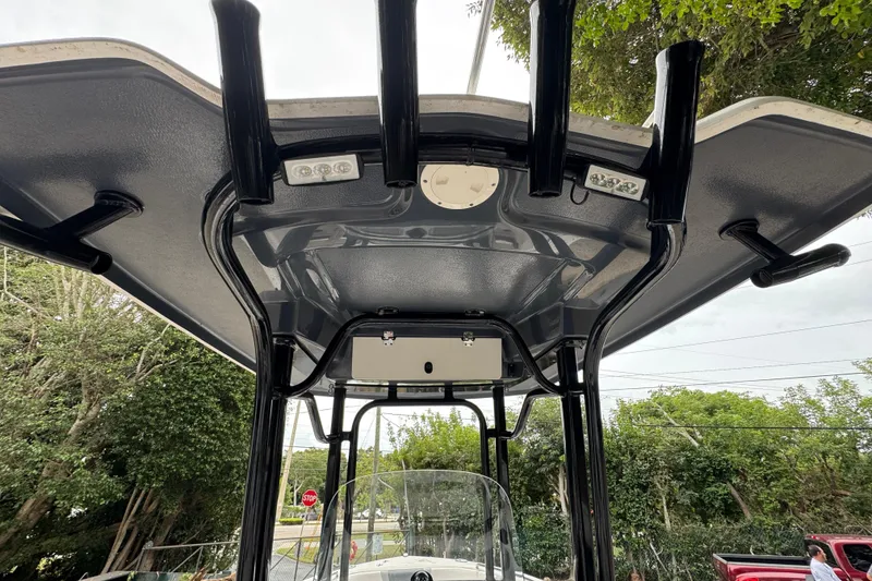 Slide: The Image of 2021 Robalo R230 Center Console boat T-top with rod holders and lights. - 19