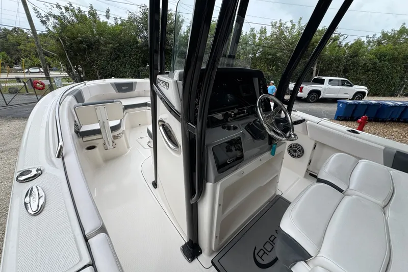 Slide: The Image of 2021 Robalo R230 Center Console boat interior with steering wheel and seating. - 20