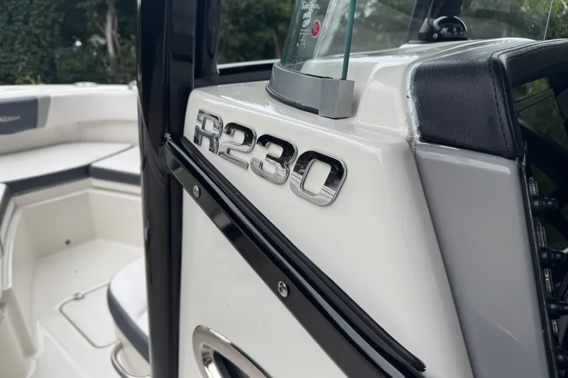 Slide: The Image of 2021 Robalo R230 Center Console boat interior with model emblem. - 21