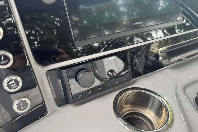 Slide: The Image of 2021 Robalo R230 Center Console dashboard with Garmin and Fusion controls. - 22