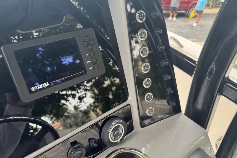 Slide: The Image of 2021 Robalo R230 Center Console dashboard with Yamaha display and control panel. - 24