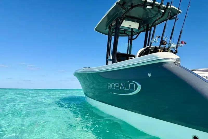 Slide: The Image of 2021 Robalo R230 Center Console boat on clear turquoise water. - 29