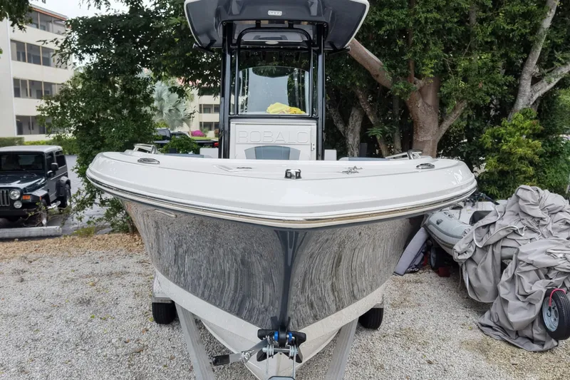 Slide: The Image of 2021 Robalo R230 Center Console boat on trailer, parked outdoors. - 3