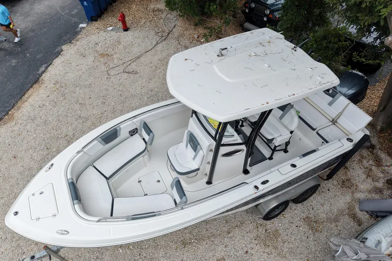 Slide: The Image of 2021 Robalo R230 Center Console boat on trailer, aerial view, parked on gravel. - 5