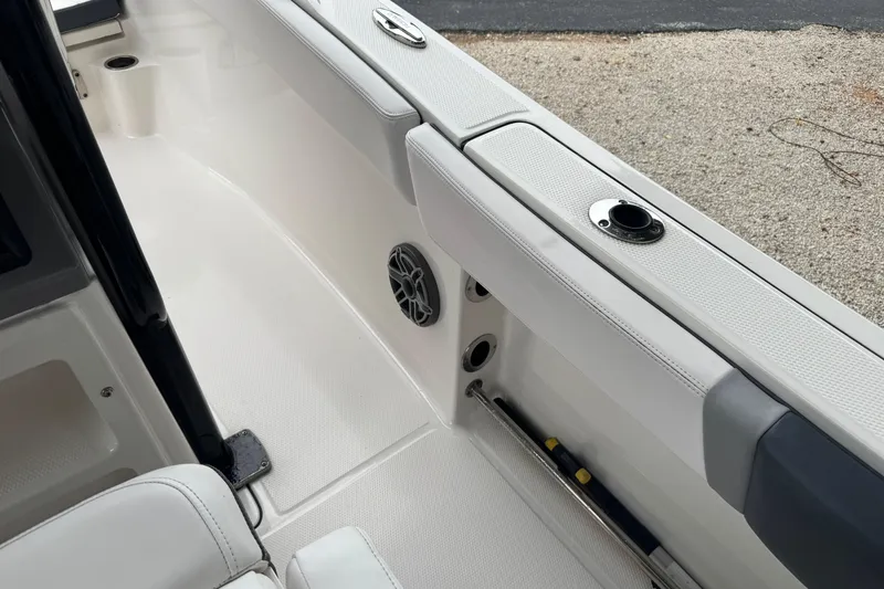 Slide: The Image of 2021 Robalo R230 Center Console boat interior with rod holders and speaker. - 8