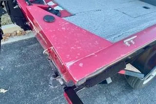 Slide: The Image of 2013 Tracker Pro Team 175 TXW boat with red exterior and carpeted deck. - 10