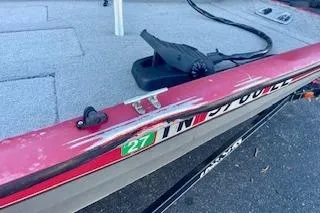 Slide: The Image of 2013 Tracker Pro Team 175 TXW boat with visible wear and registration sticker. - 11