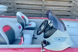 Slide: The Image of 2013 Tracker Pro Team 175 TXW boat interior with steering wheel and seating. - 12