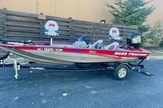 Slide: The Image of 2013 Tracker Pro Team 175 TXW bass boat on trailer, red and silver design. - 13