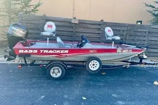 Slide: The Image of 2013 Tracker Pro Team 175 TXW bass boat on trailer, red and silver design. - 15