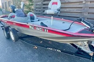 Slide: The Image of 2013 Tracker Pro Team 175 TXW fishing boat on trailer, red and gray design. - 16