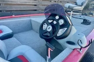 Slide: The Image of 2013 Tracker Pro Team 175 TXW boat interior with steering wheel and seating. - 3