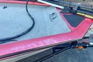 Slide: The Image of 2013 Tracker Pro Team 175 TXW boat deck with red trim and fishing equipment. - 7