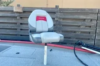 Slide: The Image of 2013 Tracker Pro Team 175 TXW boat seat with wooden fence background. - 8