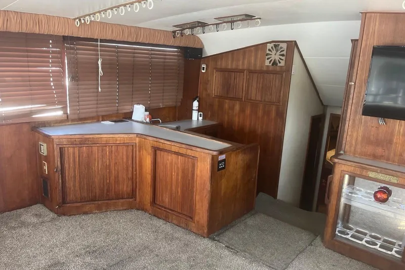Slide: The Image of Interior of 1989 Topaz 44 Sportfisherman yacht with wood paneling and carpeted flooring. - 14