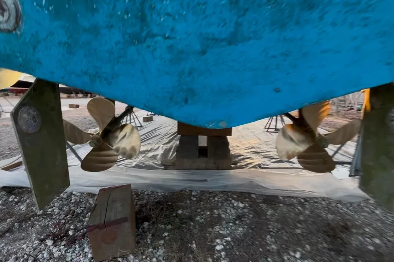 Slide: The Image of 1989 Topaz 44 Sportfisherman boat propellers and rudders on dry dock. - 19