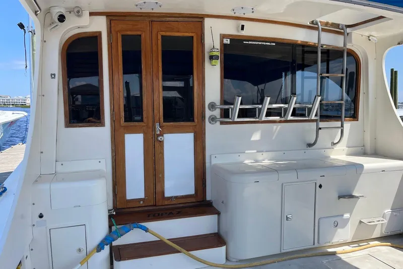 Slide: The Image of 1989 Topaz 44 Sportfisherman helm with Garmin navigation, overlooking marina and waterfront homes. - 6