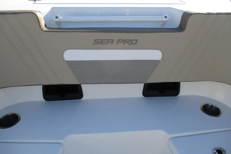 Slide: The Image of 2026 Sea Pro 292 Offshore boat interior detail with cup holders and branding. - 16