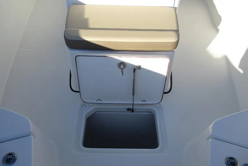 Slide: The Image of 2026 Sea Pro 292 Offshore boat interior with storage compartment and cushioned seat. - 22